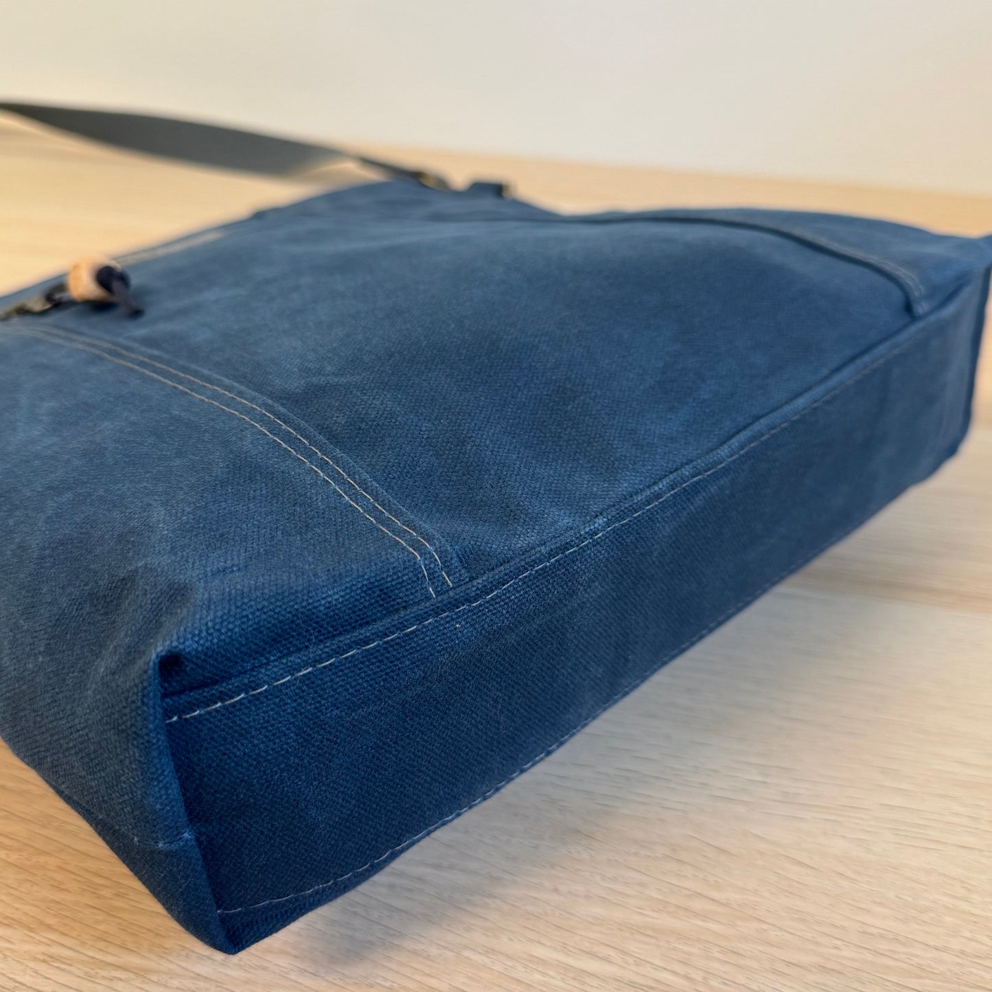 Blue denim fabric on a wooden surface